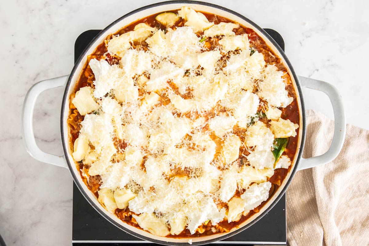 Overhead photo of vegetarian skillet lasagna with ricotta and mozzarella on top.