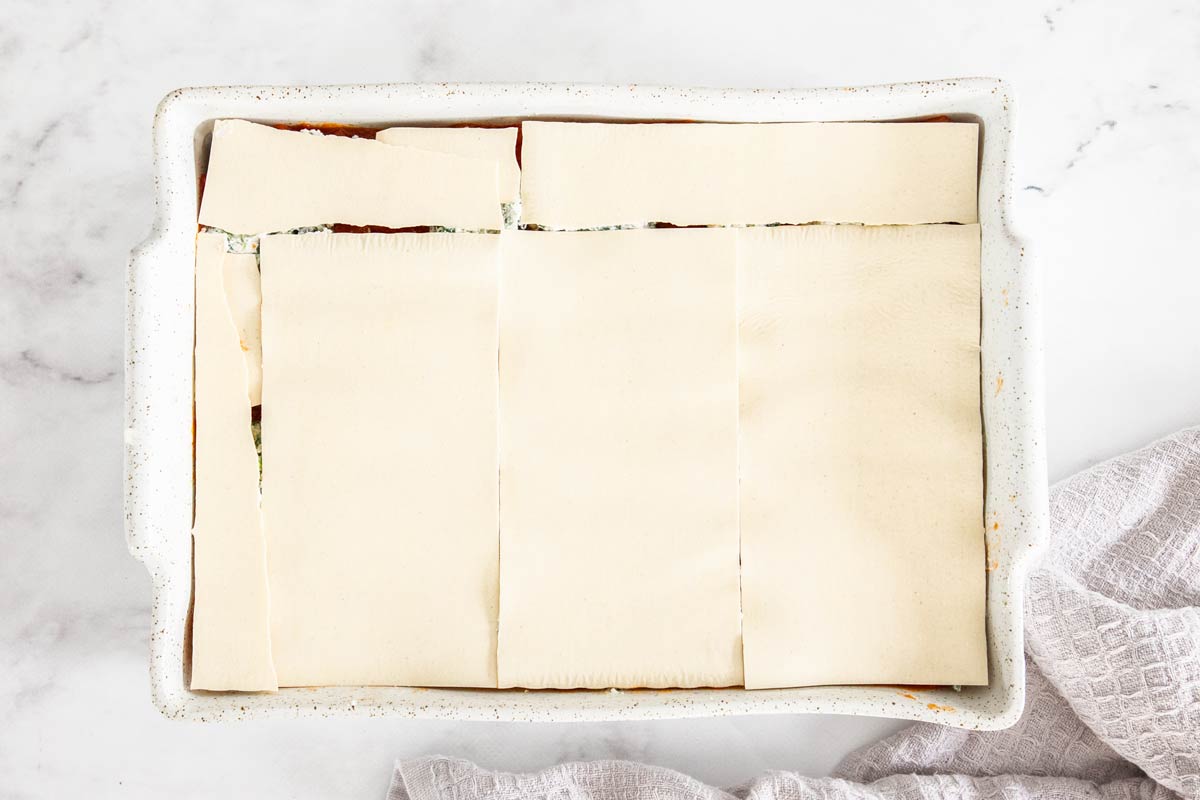 No-boil lasagna noodles over top of spinach and ricotta lasagna