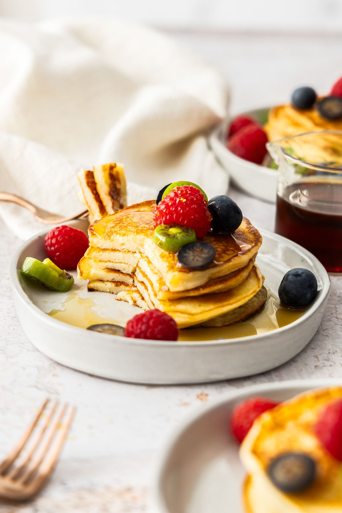 A stack of cottage cheese pancakes with a slice taken out