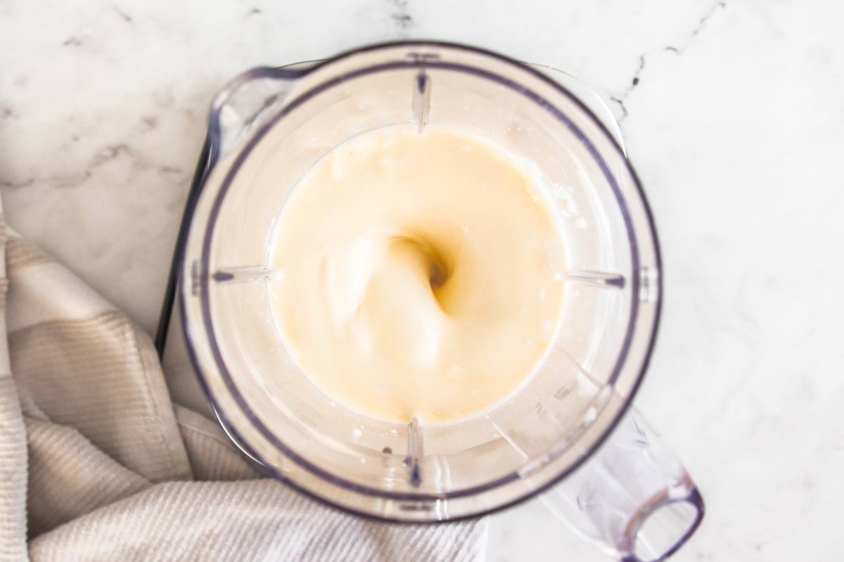 Cottage cheese, eggs, vanilla, and melted butter mixing together in a blender