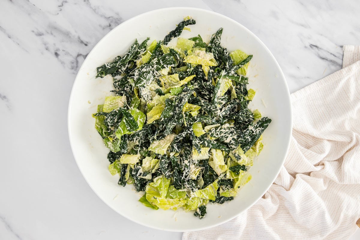 Kale and romaine caesar salad with parmesan added on top